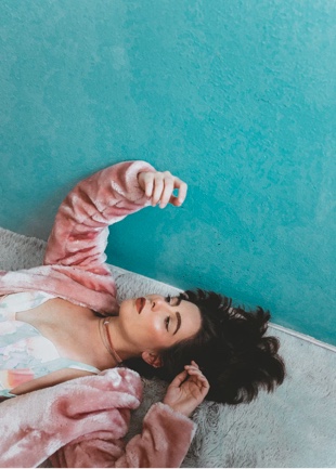 Woman in pink sweater reclining and relaxing