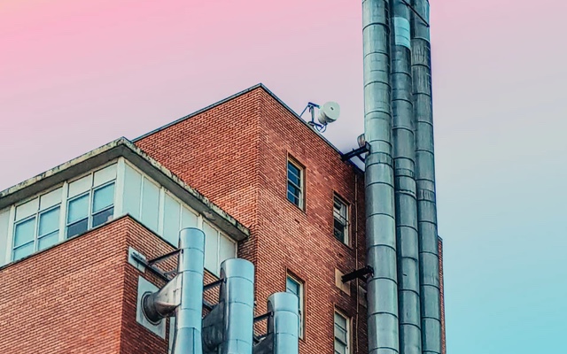 Sunset view of modern industrial loft building's top floor