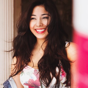 Woman with wide, excited smile staring off into the distance