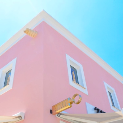Sunny, ground view of beautiful pink building